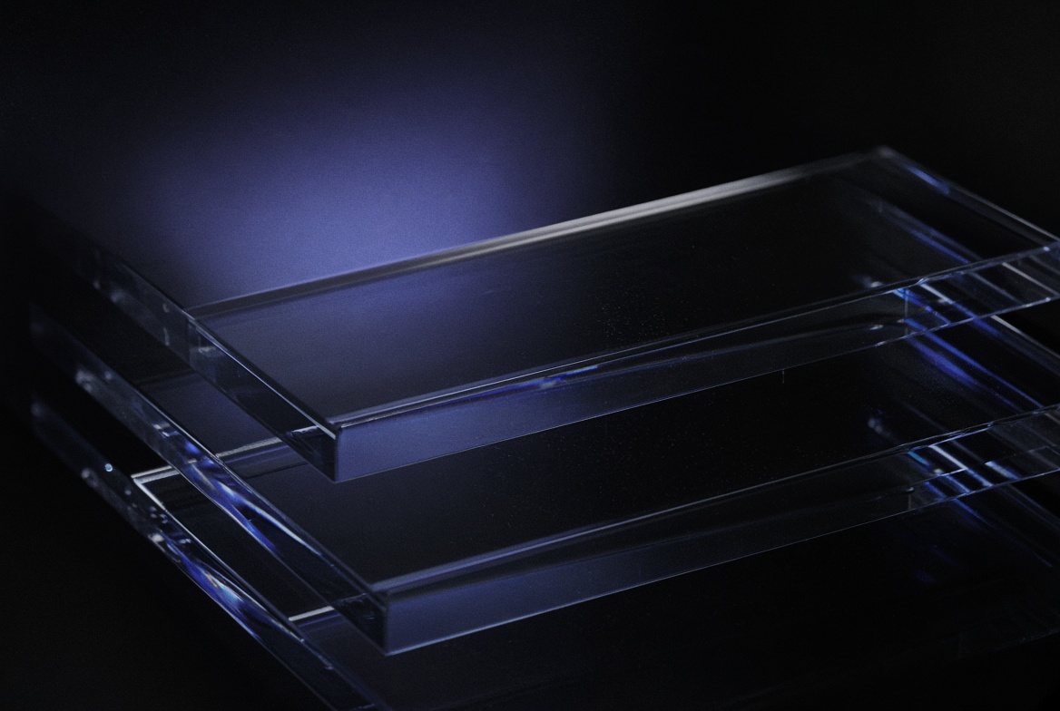 Stacked optical glass plates on black, with indigo refraction along the edges.